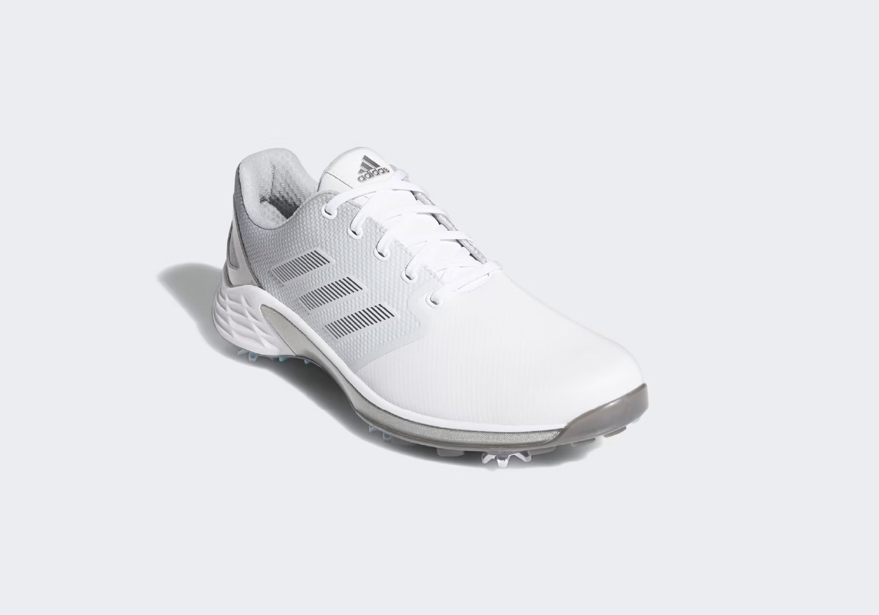 white adidas zg21 on gray background