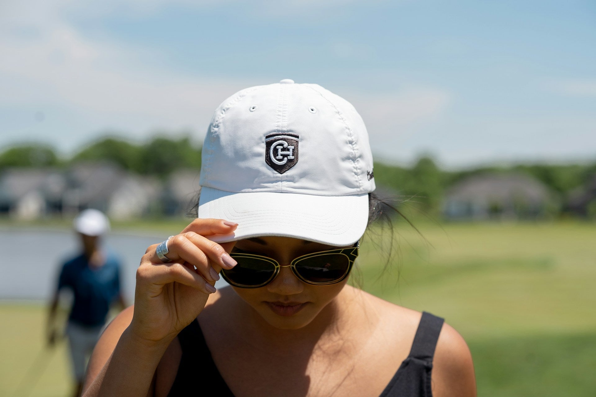 woman player wearing a hat during a sunny day of playing golf