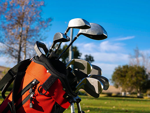 golf clubs inside a golf bag in a golf course