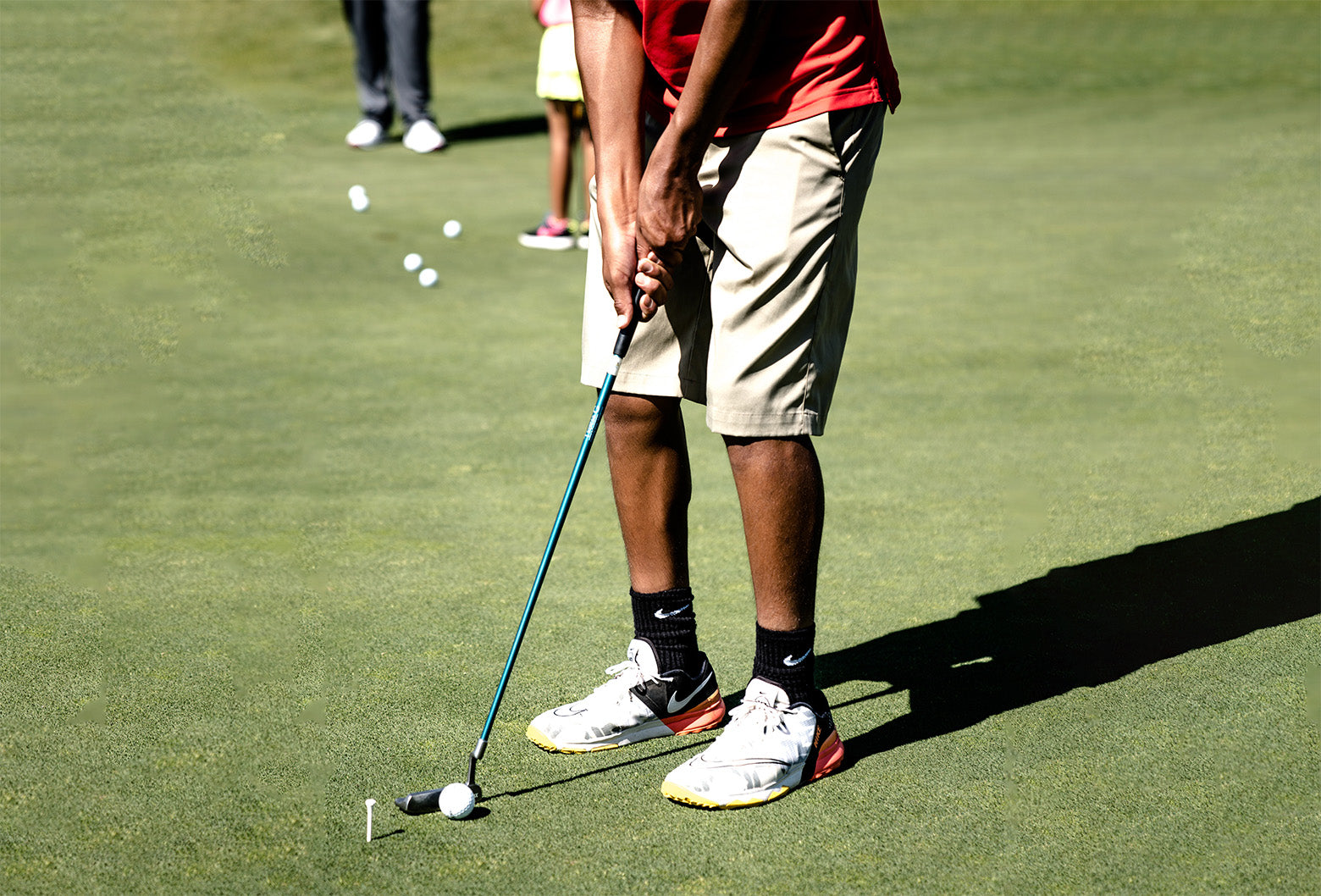 golf player holding a golf club in a golf course