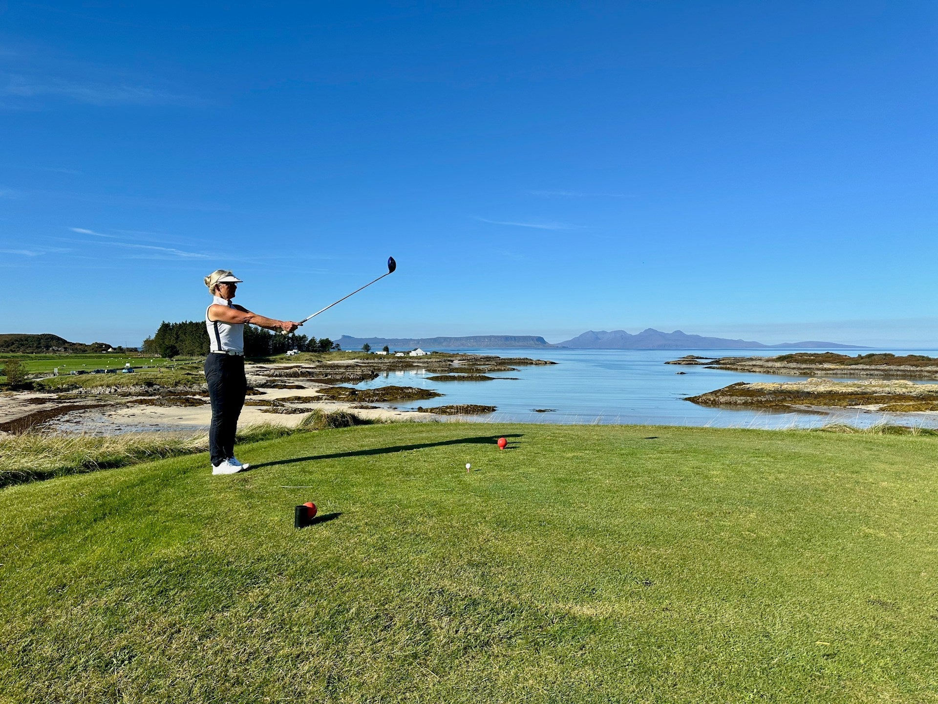 woman golf player preparing a shot in a field