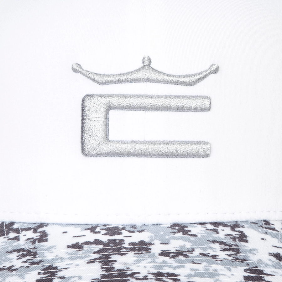 The Cobra Camo Crown C Snapback Cap is a white cap with a gray embroidered stylized C and crown logo; its brim features a bold black, white, and gray Digi-camo Color Block pattern.