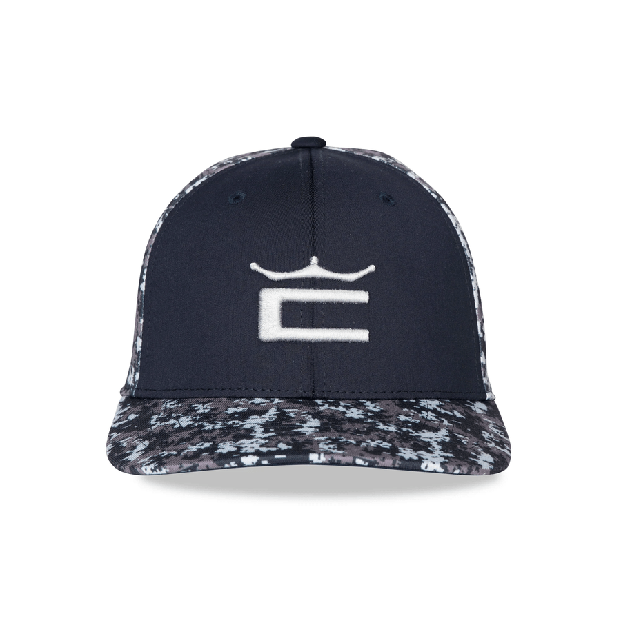 The Cobra Camo Crown C Snapback Cap in navy features a white embroidered crowned C, digi-camo color block on the bill and sides, and a Flexfit 110 Sweatband for all-day comfort.