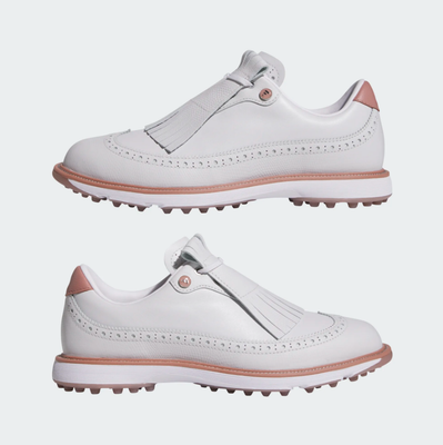 A pair of Adidas MC Zoysia Ladies Spikeless Golf Shoes in grey, styled with decorative perforations and fringe detail on top, featuring BOOST comfort. The shoes are displayed side by side on a plain light background.