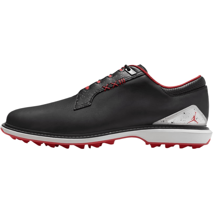 The Jordan ADG 5 Golf Shoes - Black feature red accents, a white and gray speckled heel, red outsole, subtle red stitching, low-cut design, Jumpman logo on the heel tab, Formula 23 foam cushioning, and a rubber traction pattern.