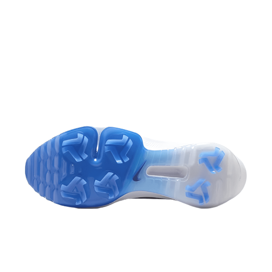 The image shows the sole of the Nike Air Zoom Infinity Tour NXT 2 Spikeless Golf Shoe - Grey/Blue, with a gradient from blue at the toe to white at the heel and hexagonal plus arrow-shaped traction patterns for grip.