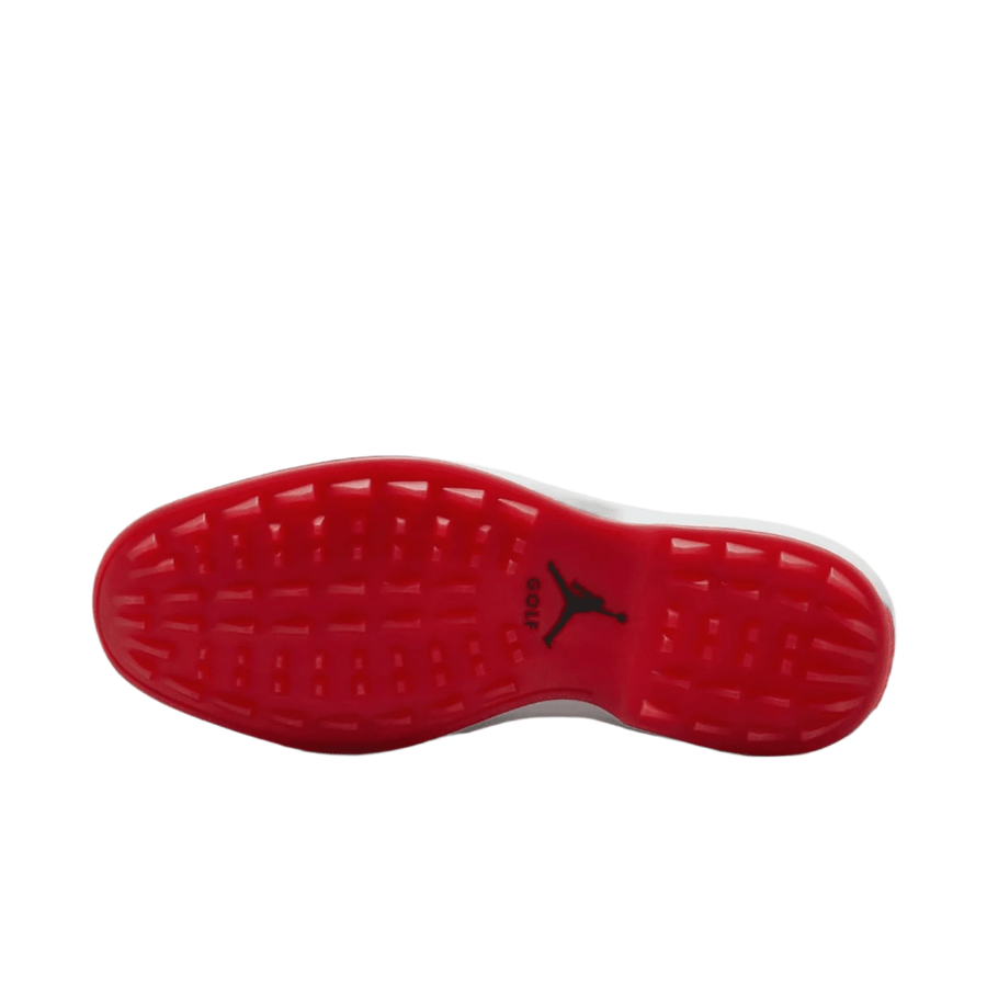 The image displays the sole of the Jordan ADG 5 Golf Shoes - Black, featuring a vivid red rubber traction pattern and a central black Jumpman logo, highlighting both style and grip from Jordan.