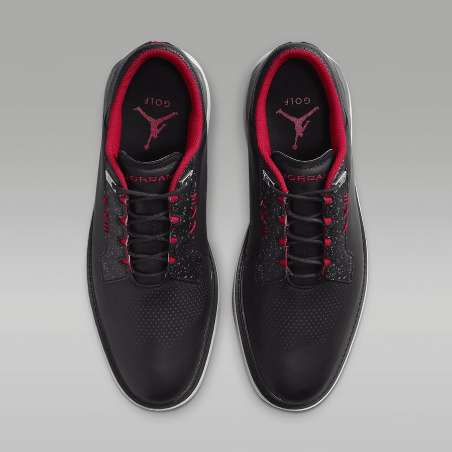 Top view of Jordan ADG 5 Golf Shoes - Black, showing red inner lining, laces, and insoles with Jumpman logo and GOLF text. Features sleek design with Formula 23 foam cushioning against a gray background.