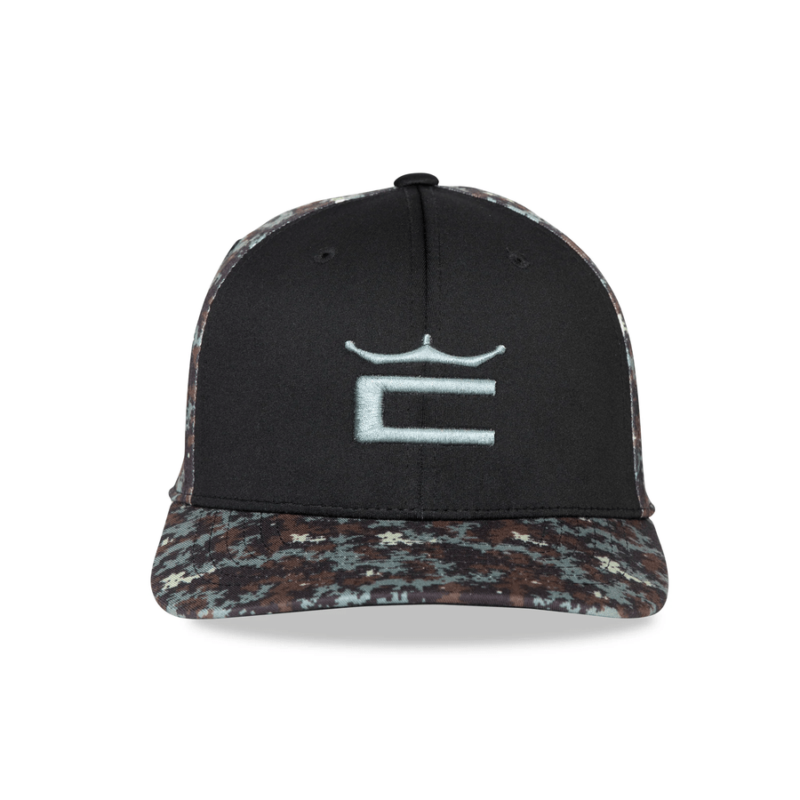 The Cobra Camo Crown C Snapback Cap features a black base, a white stylized C and crown logo on the front, and a Digi-camo Color Block pattern in shades of brown, black, and gray on the bill and sides.