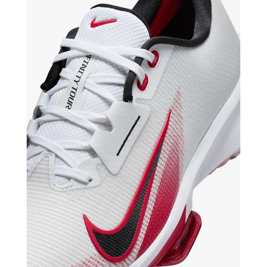 Close-up of the Nike Air Zoom Infinity Tour NXT 2 Spikeless Golf Shoe in White/Red, featuring red and black accents, an Air Zoom unit, red and black swoosh, INFINITY TOUR on the tongue, white laces, and red eyelets.