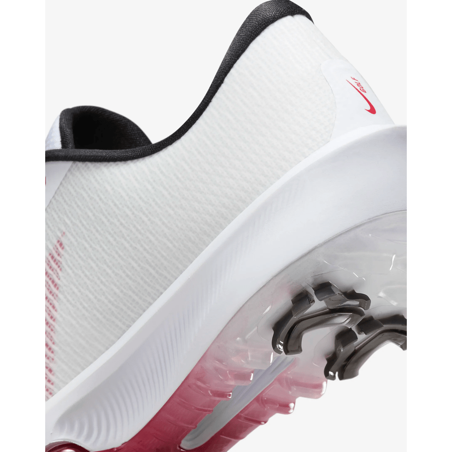 Close-up of the Nike Air Zoom Infinity Tour NXT 2 Spikeless Golf Shoe in white/red, showing the heel and sole with a black collar, red accents, and translucent outsole featuring a visible Air Zoom unit.