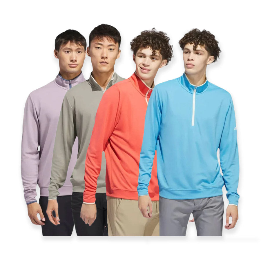 Four young men stand side by side, each wearing an Adidas Lightweight Half-Zip Top—available in lavender, gray, red-orange, and light blue—crafted from recycled materials, against a white background.