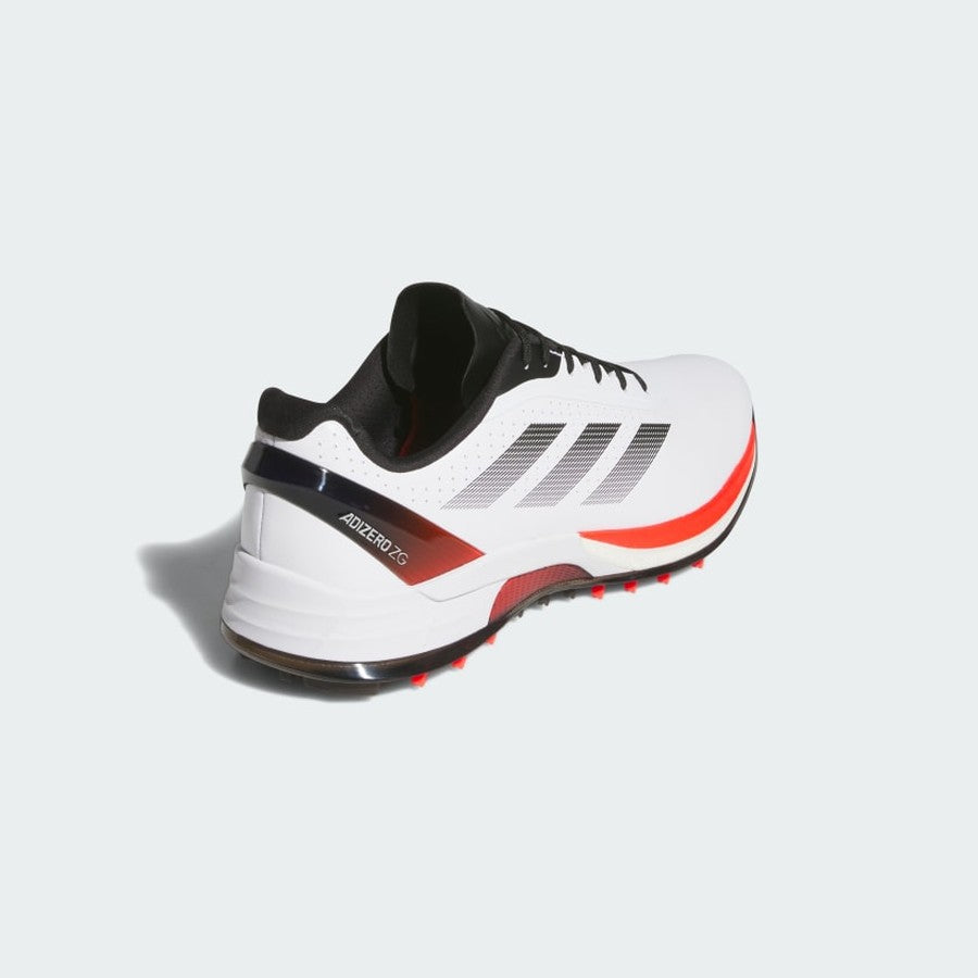 The Adidas Adizero ZG Spikeless Golf Shoes in White/Red have black and red accents, black laces, three black stripes, and a waterproof upper. They are shown from the back and side on a light background.