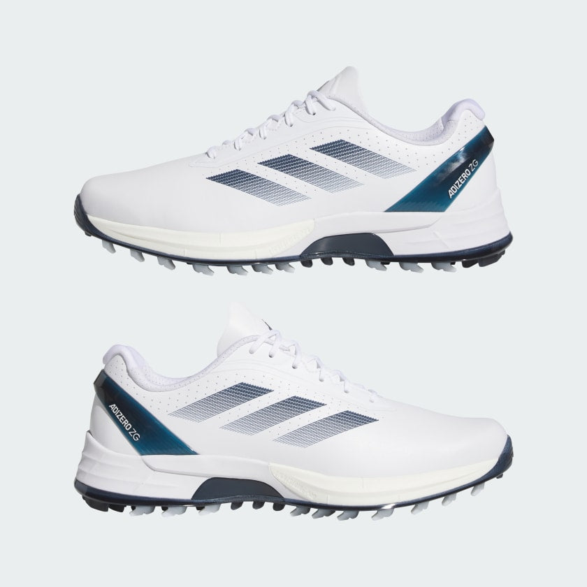 The Adidas Adizero ZG Spikeless Golf Shoes in White/Blue feature three dark stripes, dark soles, and blue heel accents with ADIDAS branding. Made from recycled and renewable materials, they are shown in a stylish side profile.