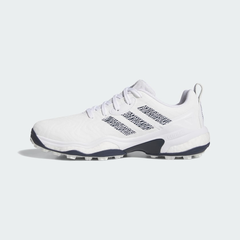 The Adidas Codechaos 25 Spikeless Golf Shoes in White/Navy feature a mesh-like upper, navy accents including three side stripes, a textured rubber sole, a heel pull tab, and are made with recycled materials.