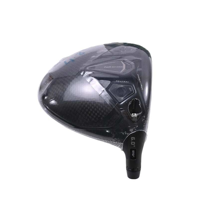 A close-up of the Cobra Darkspeed Tour Issue Long Drive LS Driver with HZDRUS Green Shaft shows its black carbon fiber clubhead, loft and adjustment markings near the hosel, and protective plastic partially covering the head.