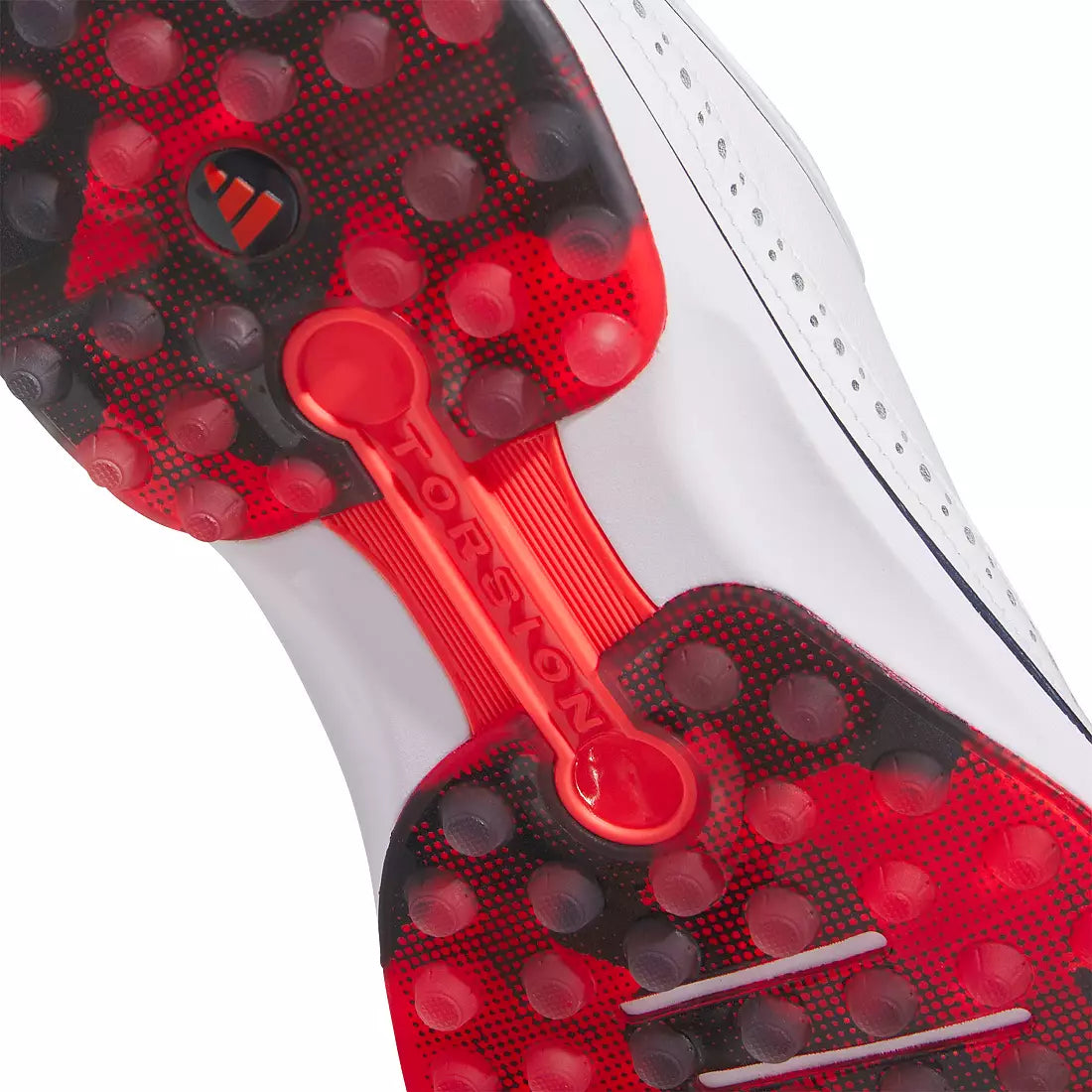 Close-up of the Adidas MC80 Golf Shoes in White/Red, showing a red and black sole with circular grips, visible TORSION bar for support, and BOOST midsole cushioning for comfort.