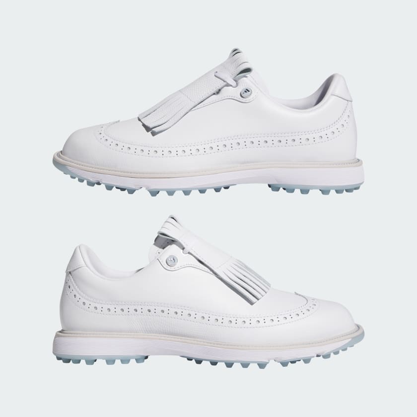 The Adidas MC Zoysia Ladies Spikeless Golf Shoes in white feature light blue soles, decorative perforations, large fringe tassels, and adidas BOOST comfort. Shown from the side on a plain light background.