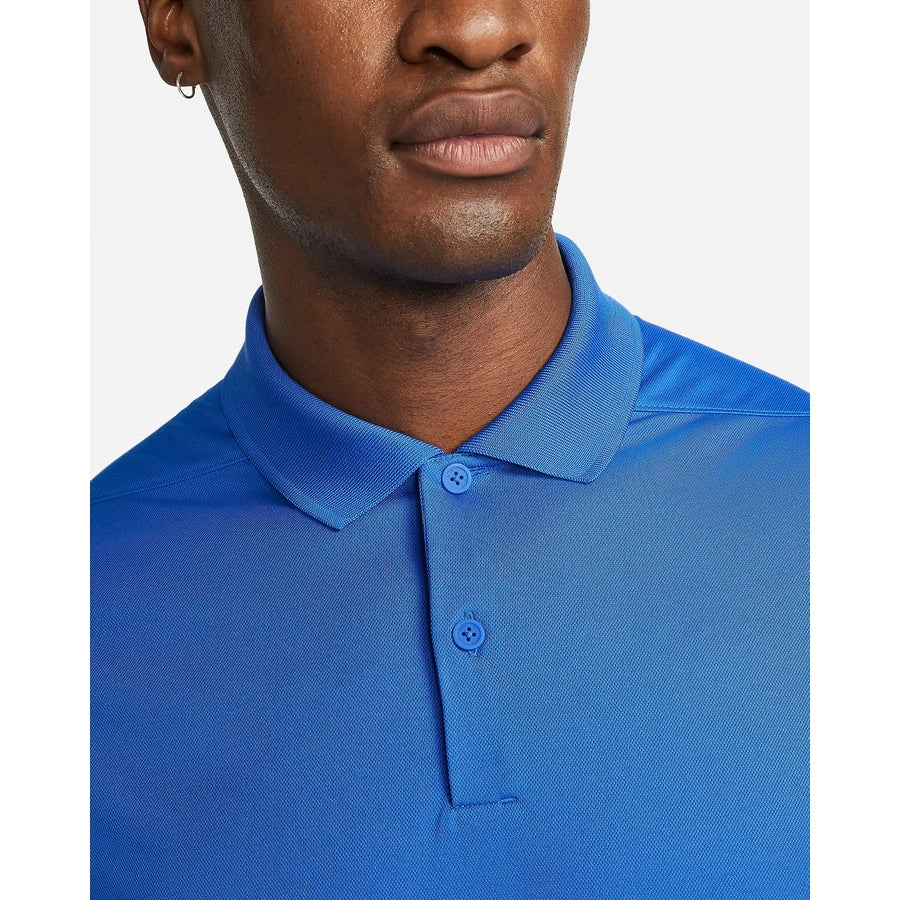 Close-up of a person wearing the Nike Dri-FIT Victory Men's Golf Shirt - Course/Event Logo - Final Sale, bright blue, with a two-button placket and classic collar; face is partially visible from the nose down.