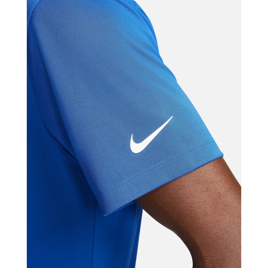 A close-up of someone wearing the Nike Dri-FIT Victory Men's Golf Shirt—Course/Event Logo, featuring a white swoosh on the sleeve and lightweight fabric for golf performance. Final sale.