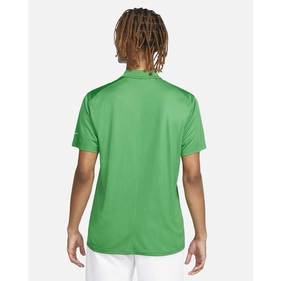 A person with braided hair, seen from behind against a white background, wears a green Nike Dri-FIT Victory Men's Golf Shirt—Course/Event Logo (Final Sale)—paired with white shorts.