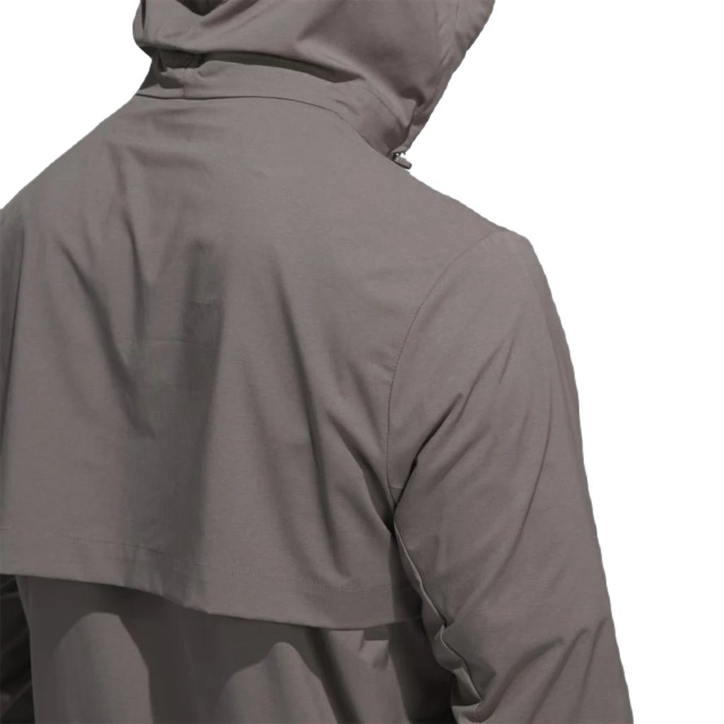 A person wearing the Adidas Ultimate365 WIND.RDY Convertible Jacket in brown is seen from behind, displaying the upper back and hood against a plain white background.