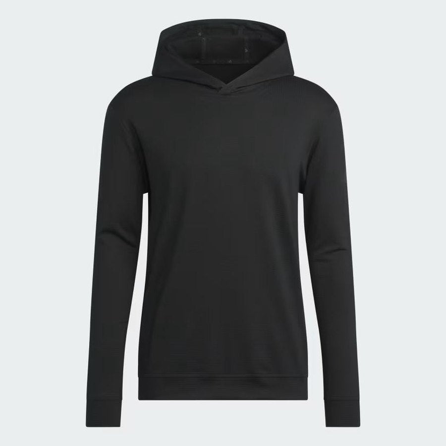 The Adidas Ultimate365 Elevated Pullover Hoodie is a plain black long-sleeve golf hoodie made with recycled materials, featuring a front pocket and no visible logos or designs, shown against a light gray background.