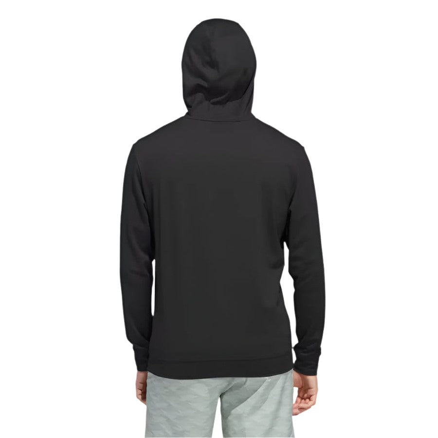A person wearing the Adidas Ultimate365 Elevated Pullover Hoodie in black and light gray shorts stands with their back to the camera, hood up, against a plain white background.