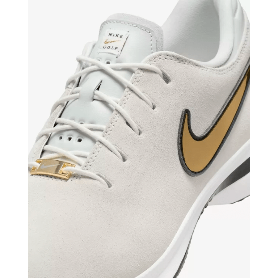Close-up of the Nike Air Zoom Victory Tour 3 NRG Golf Shoes in White/Gold, featuring premium full-grain leather, white laces, a gold Nike swoosh, and a tongue with a small NIKE GOLF label.
