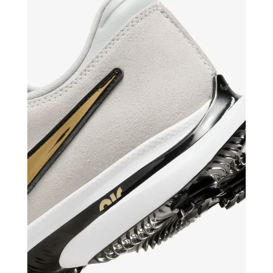 Close-up of the heel of the Nike Air Zoom Victory Tour 3 NRG Golf Shoes in White/Gold, featuring a gold swoosh, black and white midsole with visible Air cushioning, premium full-grain leather upper, and a textured black outsole for traction.