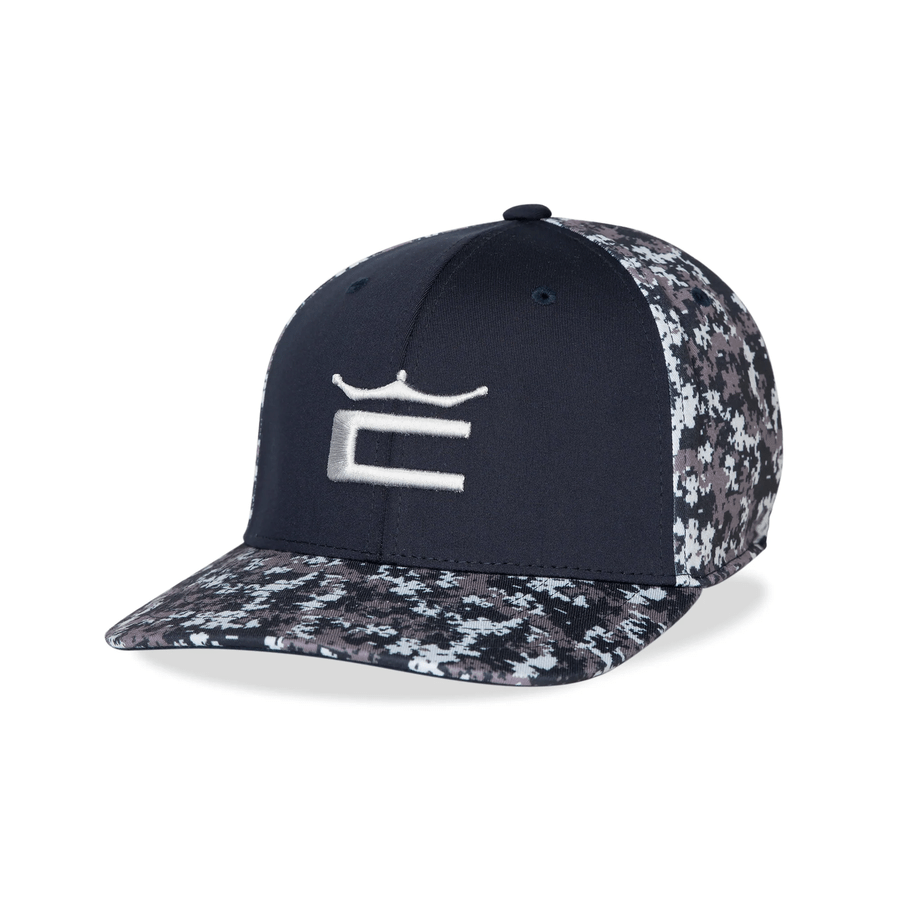 The Cobra Camo Crown C Snapback Cap features a black camo design, digi-camo brim and panels, a white embroidered crown C on the front, and a Flexfit 110 sweatband for comfort.