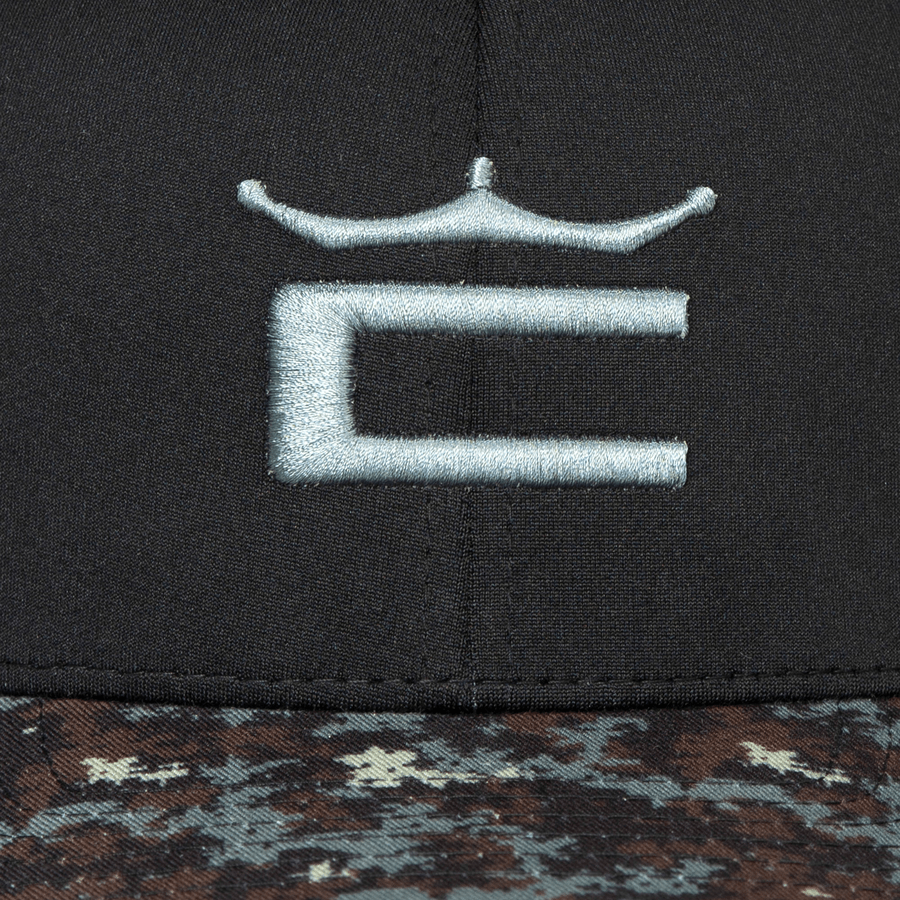 Close-up of the Cobra Camo Crown C Snapback Cap in black, featuring a gray embroidered C with a crown and a brown and black digi-camo color block brim accented with light blue.
