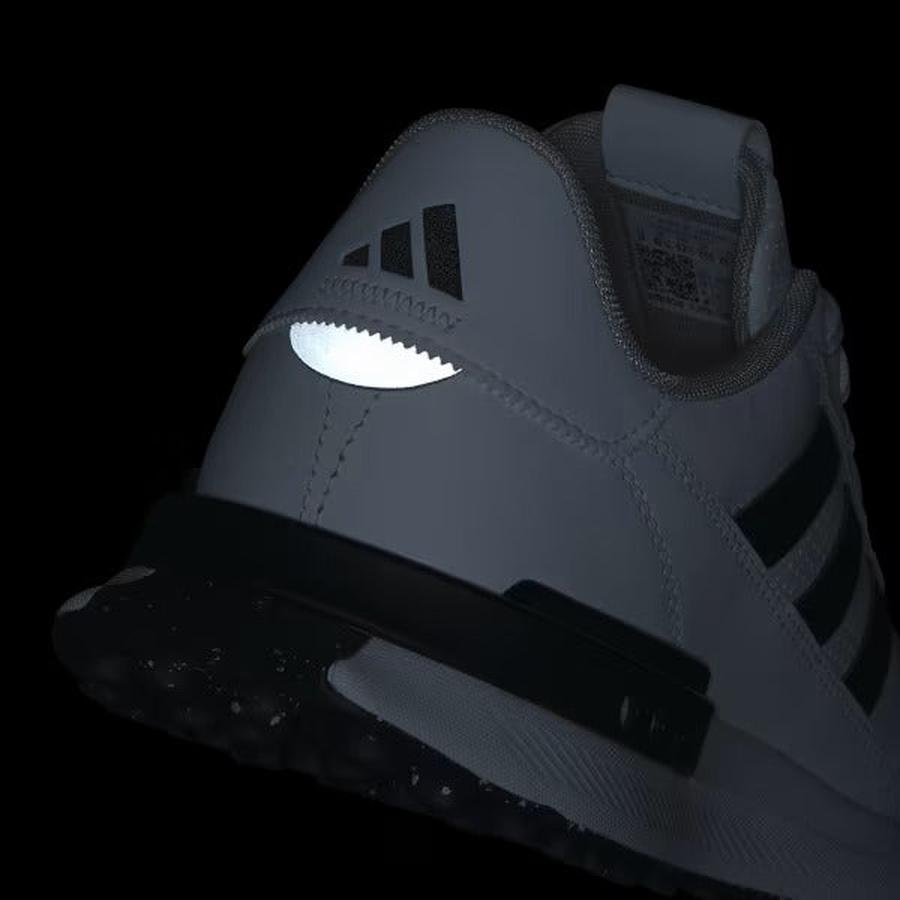 A close-up of the back of the Adidas S2G 24 Leather Spikeless Golf Shoes in White/Black, showing black stripes and a reflective heel detail against a black background.