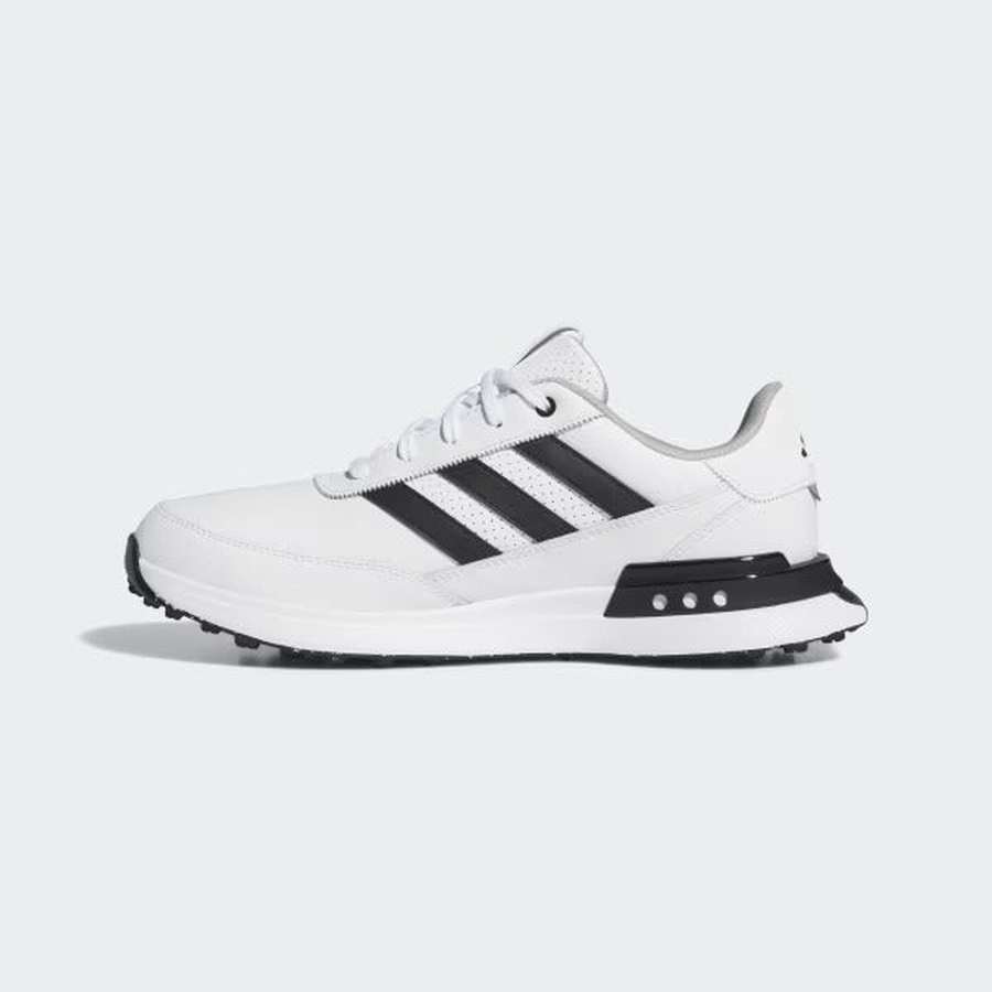 The Adidas S2G 24 Leather Spikeless Golf Shoes in White/Black feature a lace-up design, black stripes, and a textured sole, inspired by running-style golf shoes, displayed on a plain light gray background.