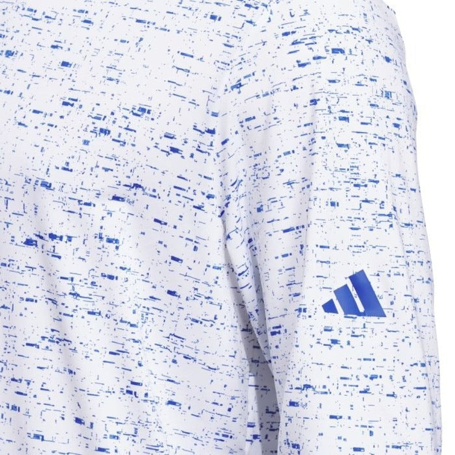 A close-up of the Adidas Core Printed Lightweight Hoodie from the two-pack, white with a blue abstract dotted pattern, stretchy fabric, and a blue Adidas logo on the sleeve.