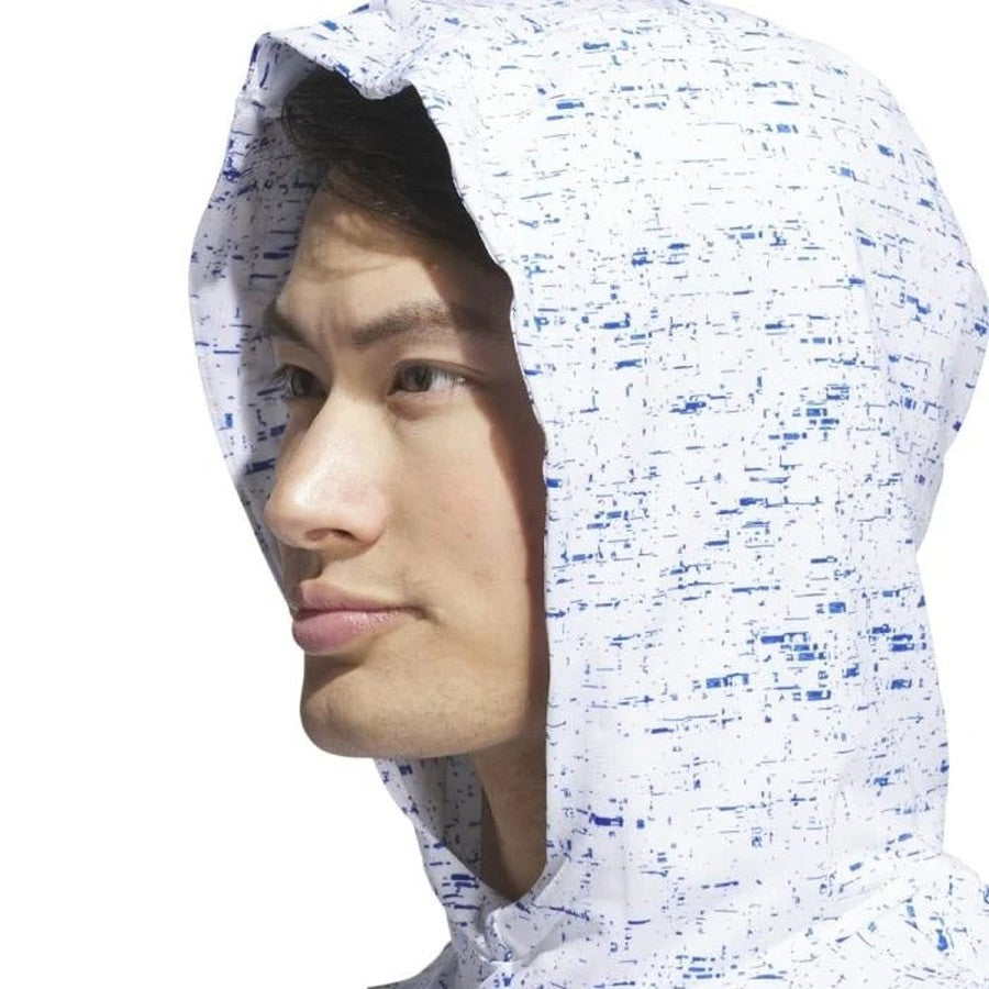 A person in a white Adidas Core Printed Lightweight Hoodie with blue speckles, sold in a two pack, looks to the side against a plain white background.