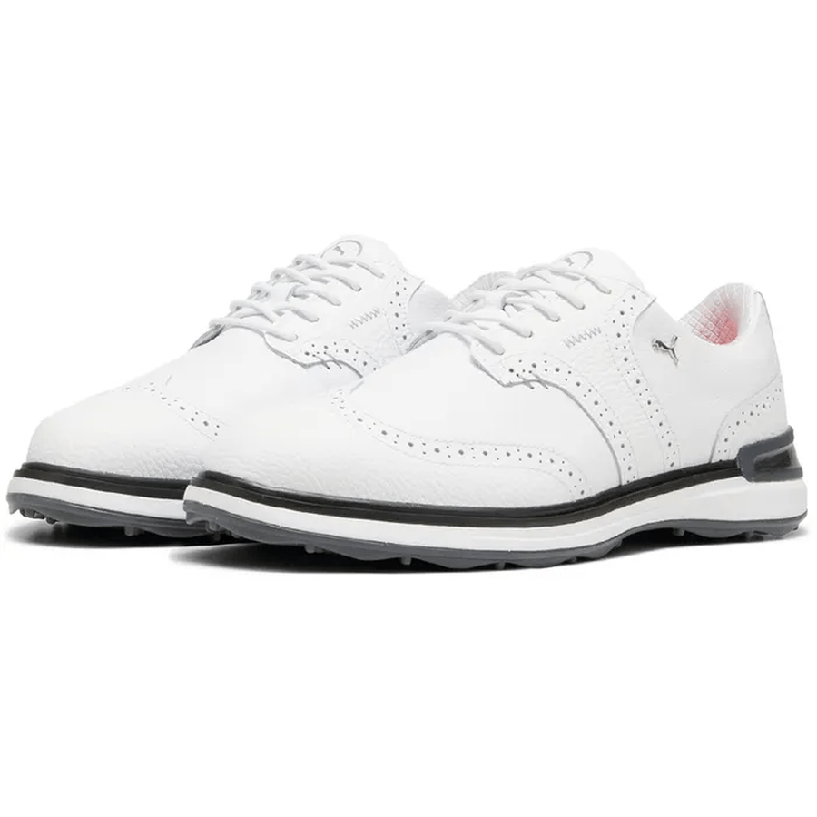 A pair of PUMA Avant Wingtip Golf Shoes in white with black and gray soles, subtle perforations, radial traction technology, a small side logo, displayed on a white background.