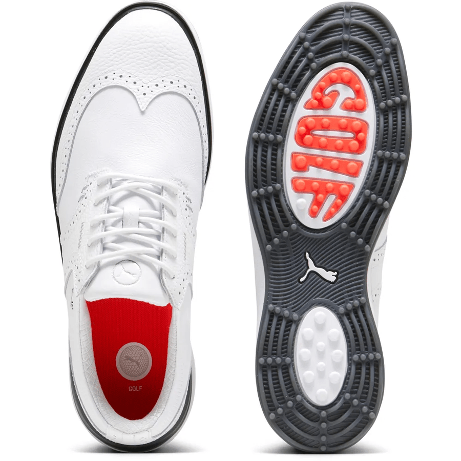 The PUMA Avant Wingtip Golf Shoes - White are displayed from above and below, highlighting a black and grey spikeless sole with radial traction, orange cushioning spelling GOLF, a Puma logo by the heel, and a red insole.