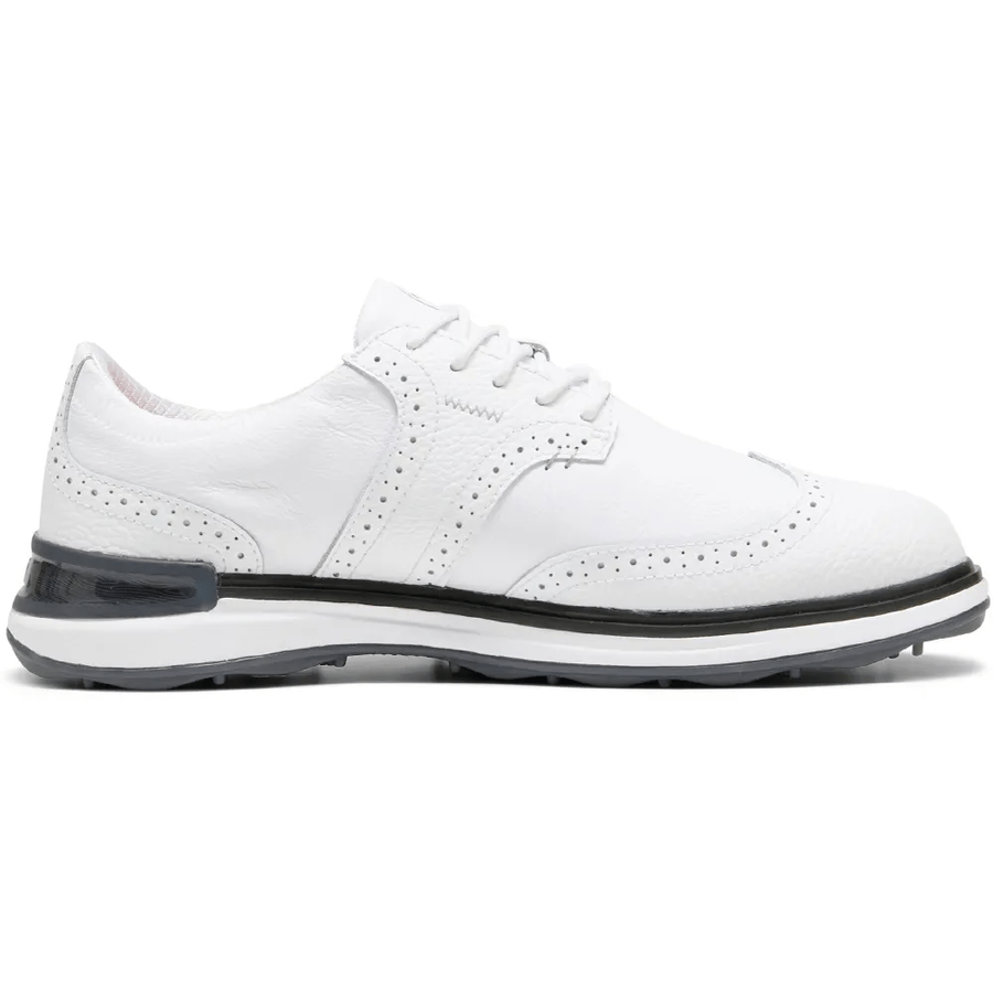 The PUMA Avant Wingtip Golf Shoes – White feature white leather with brogue detailing, a black heel accent, and a white sole with black trim. They include PUMA Golf’s innovative radial traction technology for superior grip.