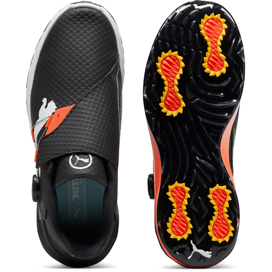 The PUMA Phantomcat Nitro Disc Golf Shoes – Black feature a white PUMA logo, textured strap, orange-yellow spiked cleats, and NITRO foam outsole for superior traction and comfort, shown from above and beneath.