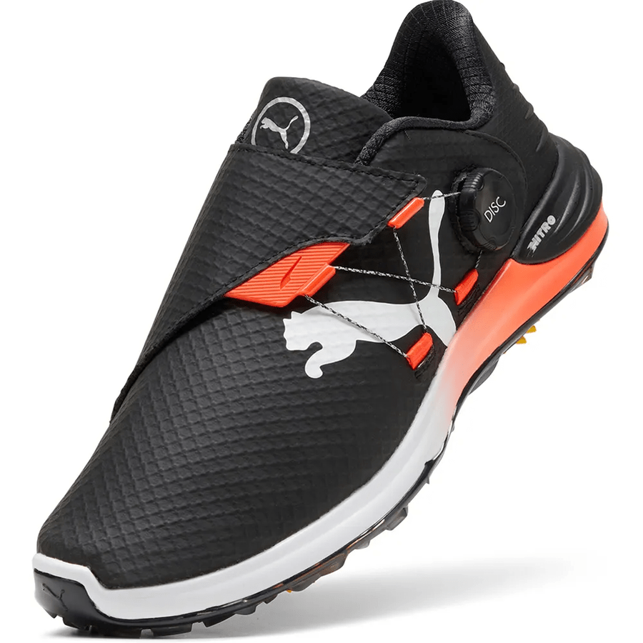 The PUMA Phantomcat Nitro Disc Golf Shoes - Black feature a textured surface, white Puma logo, orange accents, disc-based lacing system, and a thick white and orange sole with NITRO foam technology for comfort.