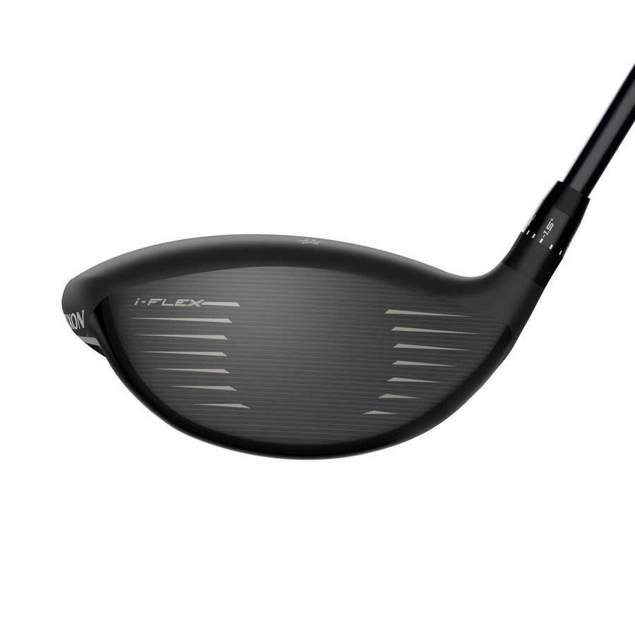 Close-up of the face of a black Srixon ZXi Max Driver golf club, showing horizontal grooves and the text I-FLEX etched on the clubface. The driver is angled on a white background.