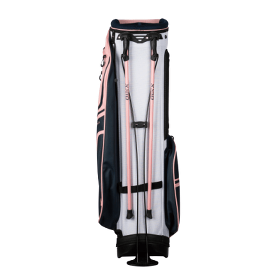 The XXIO Ladies Stand Bag offers convenient storage for all your golfing essentials, stands upright with two retractable legs, and features navy blue and light pink accents.