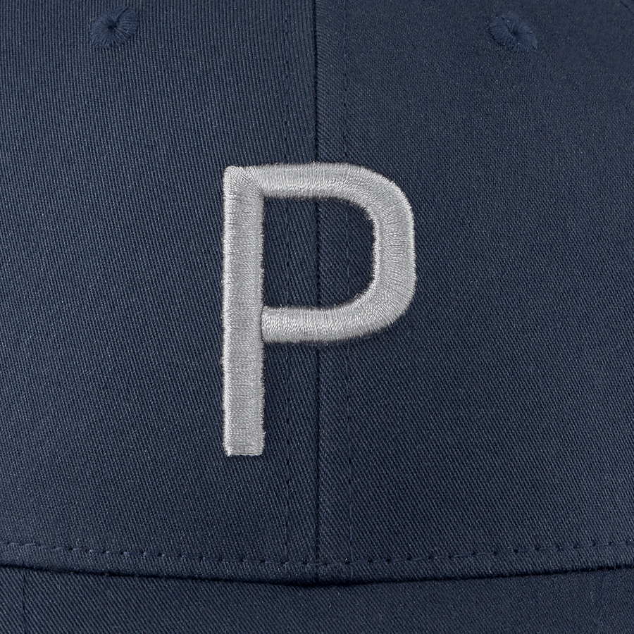 Close-up of the Puma Structured P Cap in navy blue, showcasing a large, silver embroidered P on the front and a form-fitting design.