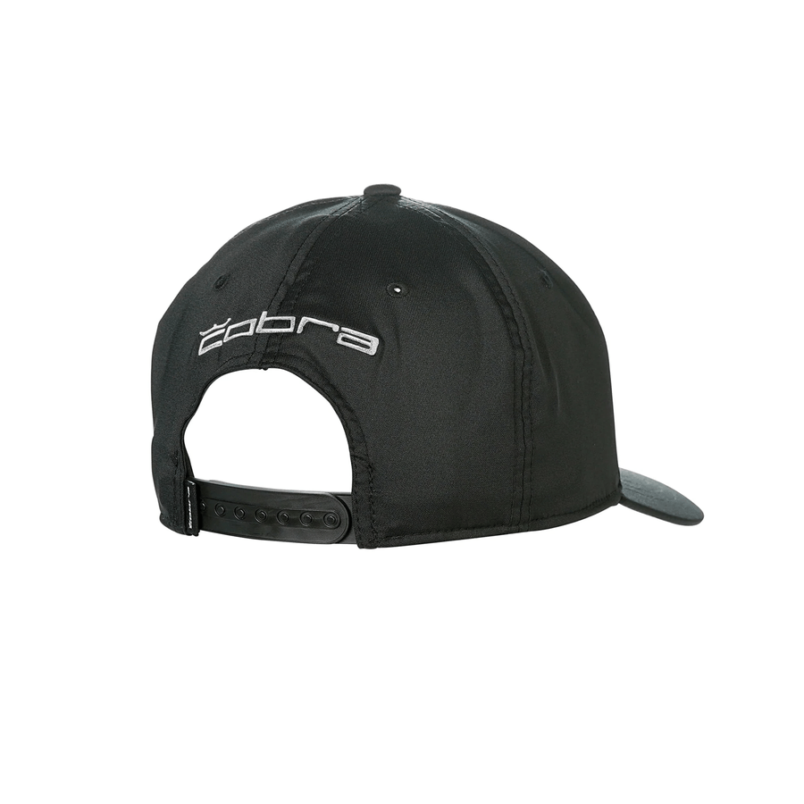 The Cobra Tour Crown Snapback Cap is a black cap with Cobra embroidered in white above the adjustable snap closure, shown from the back. It features a moisture-wicking sweatband for added comfort.