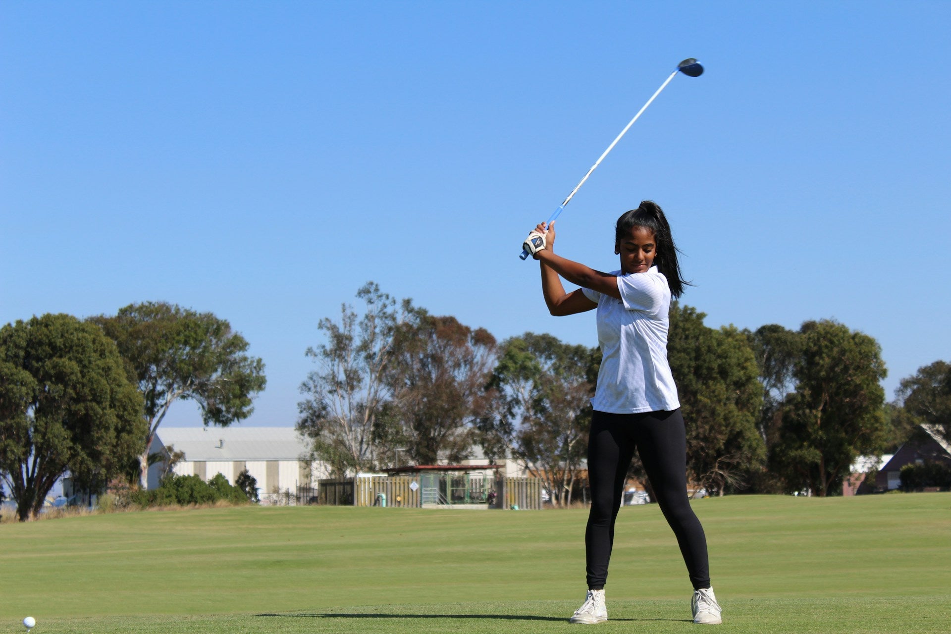 woman golf player wearing ladies golf clothes by the common rules and dress code