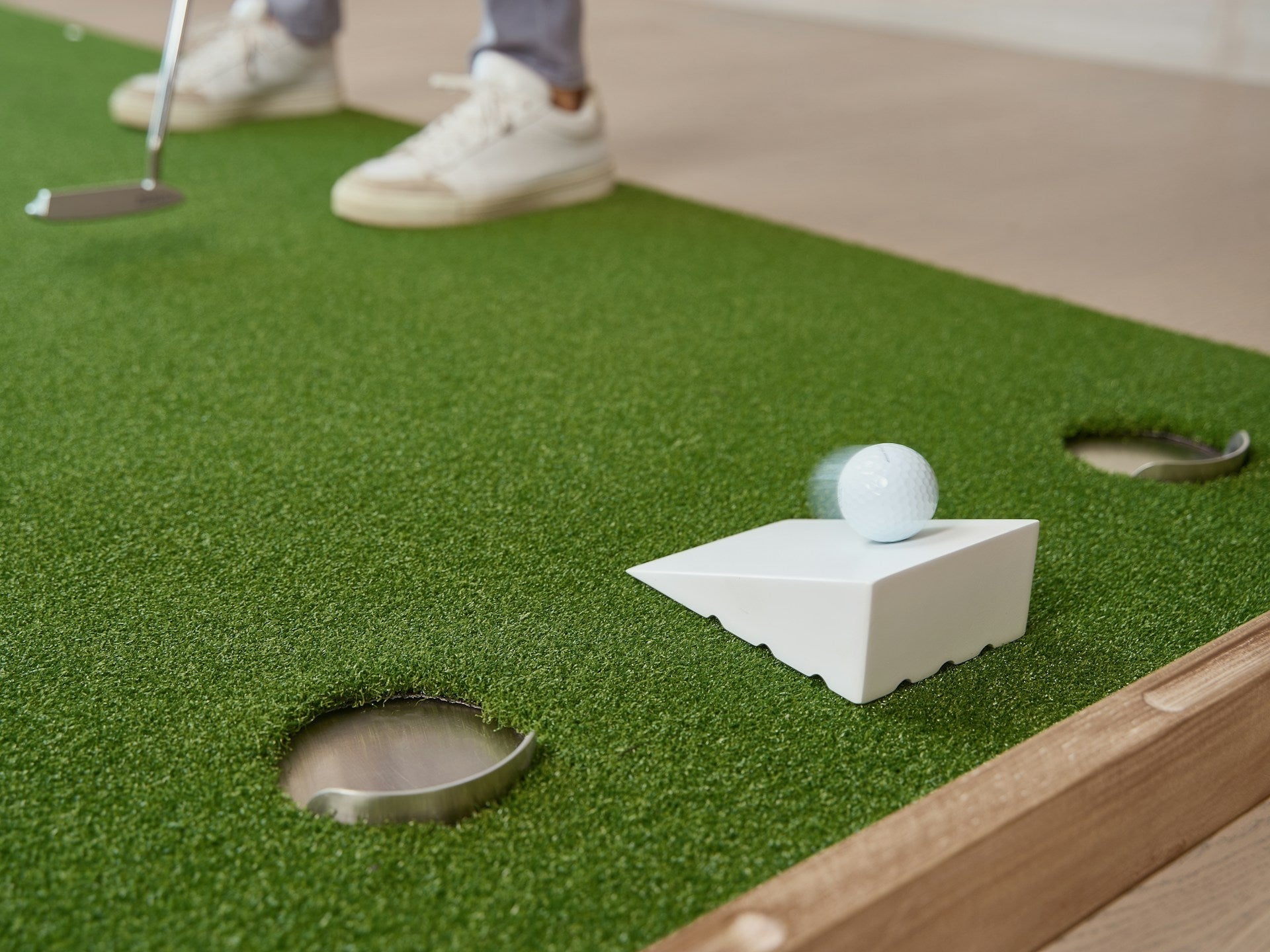 golf player practicing putting at home