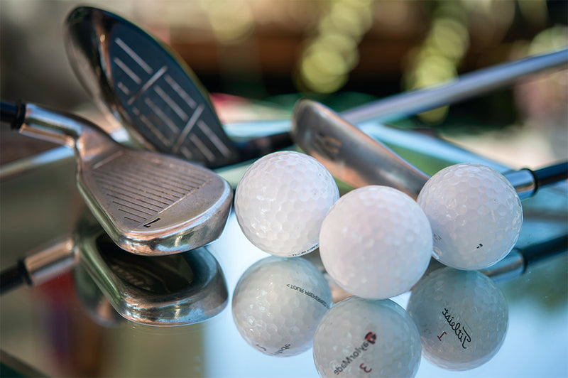 game improvement irons in a glass table with golf balls