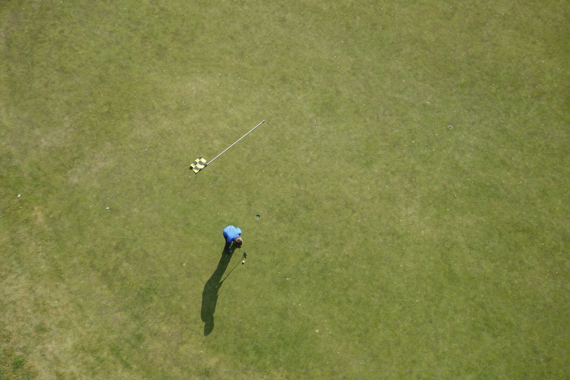 golfer in a field wearing a adidas collarless golf shirt