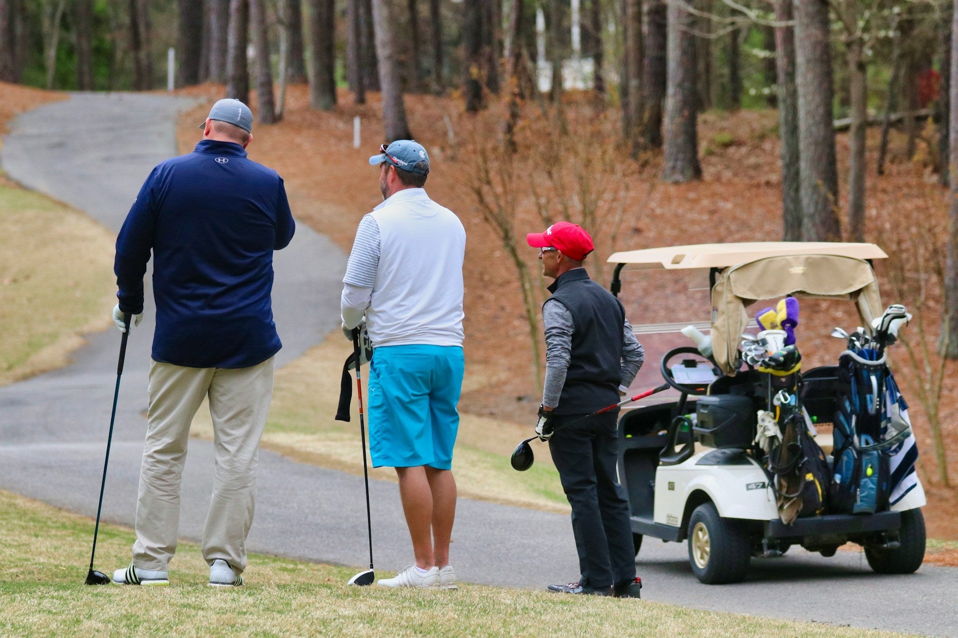golf players in a course during a match checking their golf handicap